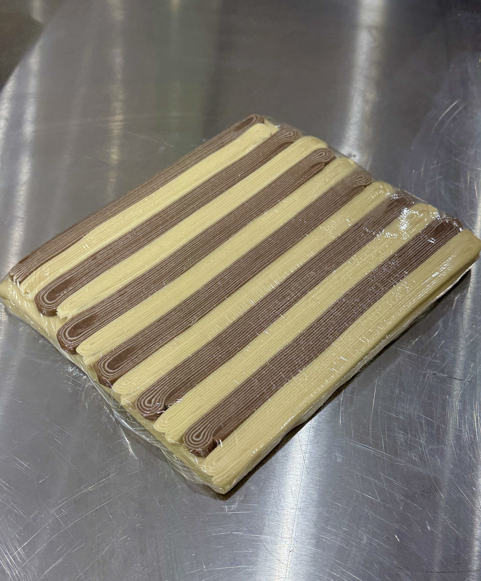 Sheet of bicolor laminated dough on the bench