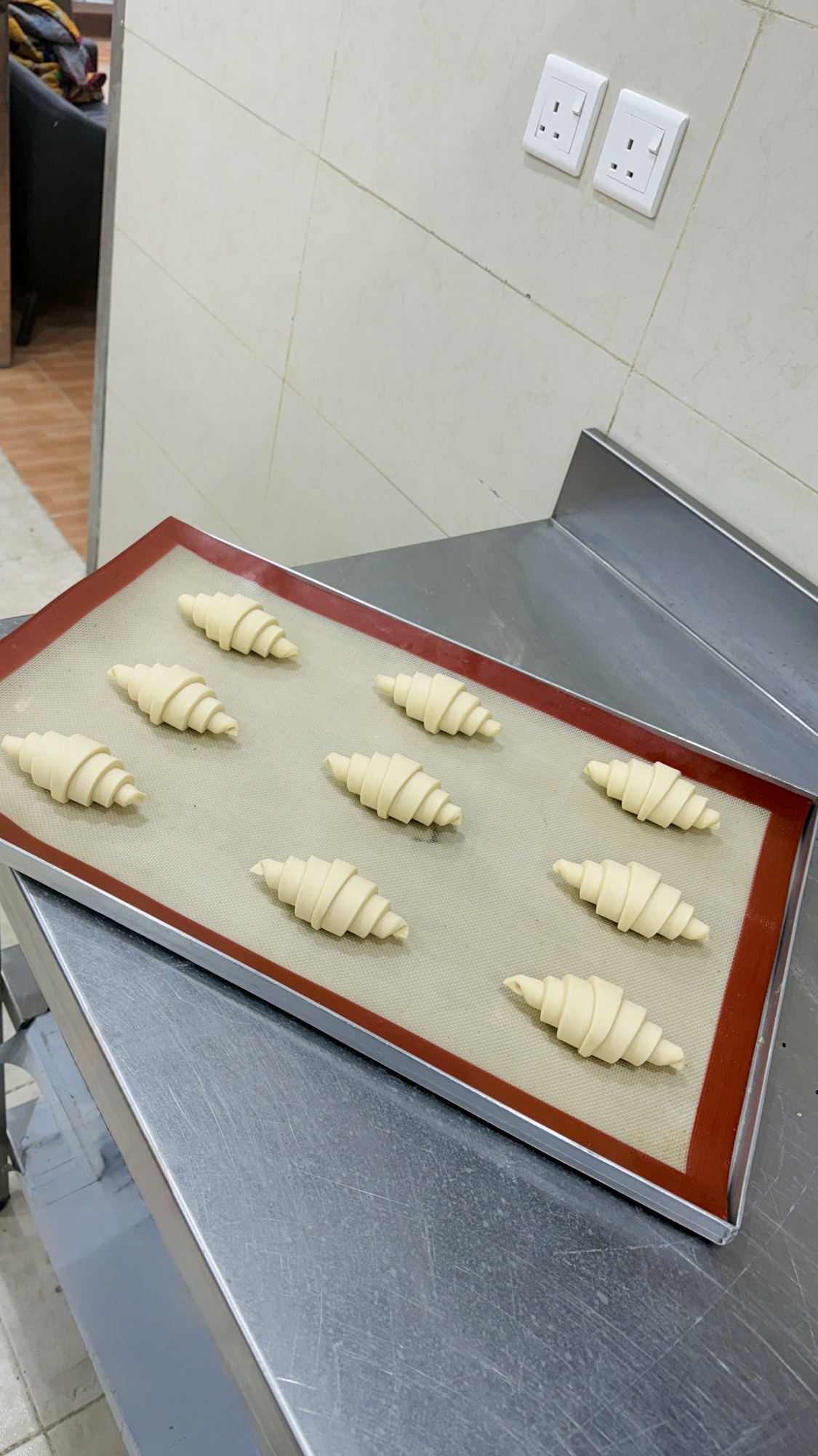 Shaped croissants proofing on a tray